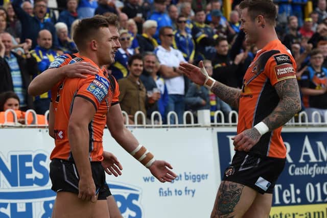 Tigers Greg Eden with Michael Shenton &  Zac Hardaker after Eden grabs try two of first half hat trick