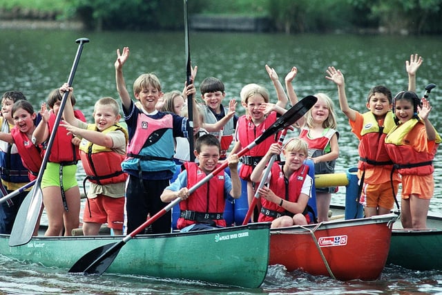A smile and a wave from these youngsters celebrating Playday at Three Sisters Park in Ashton in 1999