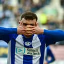 Jonny Smith celebrates scoring Latics' goal in the first half