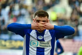 Jonny Smith celebrates scoring Latics' goal in the first half