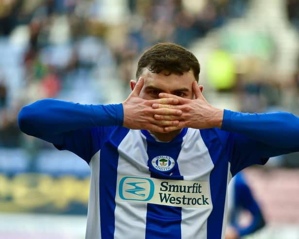 Jonny Smith celebrates scoring Latics' goal in the first half