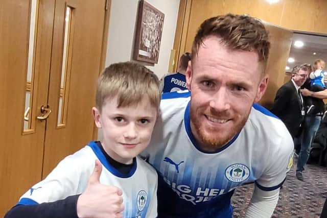 Finley McKeown with Latics player Tom Naylor