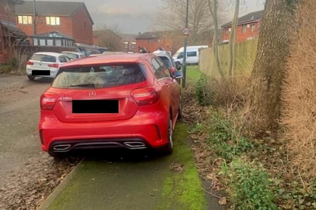 Cars so far on the pavement that pedestrians have no chance of passing safely