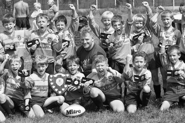 Winners of the Wigan Observer Grass Roots Rugby League Tournament, Orrell St. James celebrate after beating Leigh East 30-12 in the final at Ashton on Sunday 7th of June 1992.