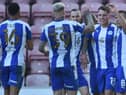 Jason Kerr accepts the celebrations from his team-mates after scoring the second goal