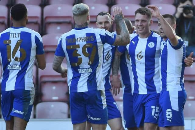 Jason Kerr accepts the celebrations from his team-mates after scoring the second goal