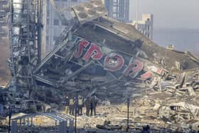 People examine the damage after shelling of a shopping centre, in Kyiv, Ukraine. Eight people were killed in the attack