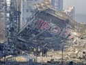 People examine the damage after shelling of a shopping centre, in Kyiv, Ukraine. Eight people were killed in the attack