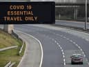 A motorway sign on the M8 advising on essential travel only (Photo: Jeff J Mitchell/Getty Images)