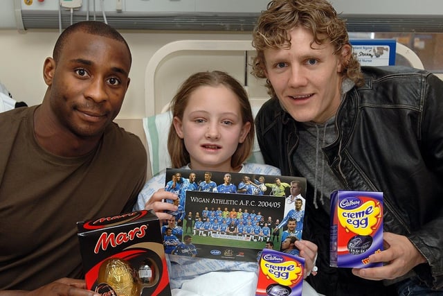 Charlotte Stockley, 12, from Pemberton, with Wigan Athletic stars Jason Roberts and Jimmy Bullard during their visit with fellow players Nathan Ellington and Alan Mahon to give out Easter Eggs to children on Wigan Infirmary's Rainbow Ward