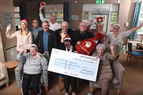 Three ward councillors of Wigan Central bring a little Christmas cheer to the staff and residents of  Alexandra Nursing Home at Whelley with a £250 cheque for a Christmas party.