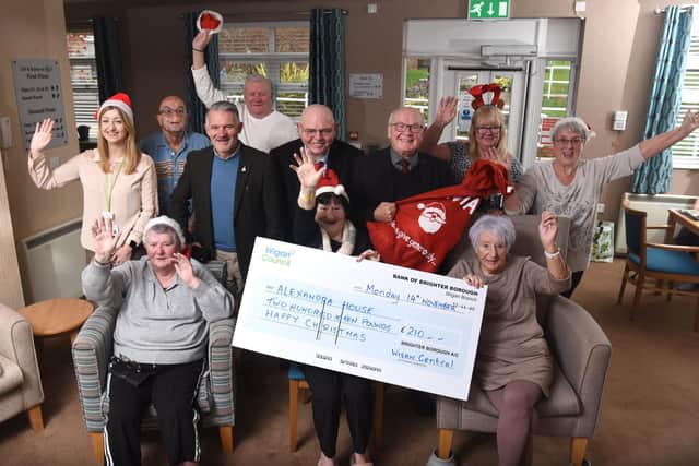 Three ward councillors of Wigan Central bring a little Christmas cheer to the staff and residents of Alexandra Nursing Home at Whelley with a £250 cheque for a Christmas party.