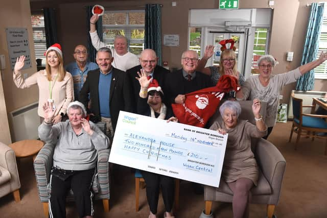 Three ward councillors of Wigan Central bring a little Christmas cheer to the staff and residents of  Alexandra Nursing Home at Whelley with a £250 cheque for a Christmas party.