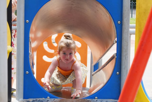 Marlie Mitchell, two, has fun in the sun at Mesnes Park, Wigan.