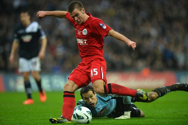 Callum McManaman scores Wigan's second goal as Millwall's Irish goalkeeper David Forde (down) looks on
