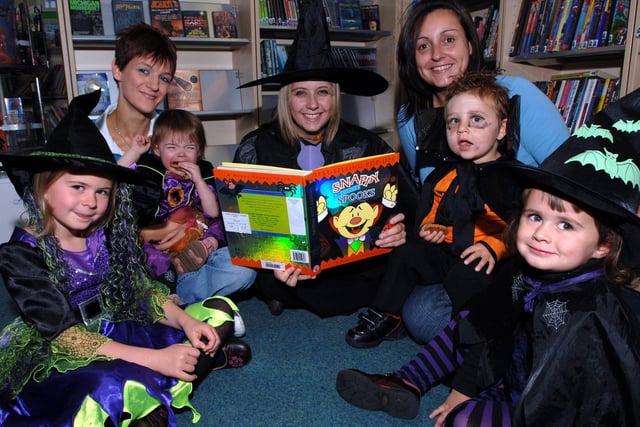 Ashton Library holds a themed Halloween reading day for toddlers. Pictured with library assistant Louise Hartley, centre, are Niamh, Carrie Knox with daughter Faith, Toni Lewis with son Robert and Grace