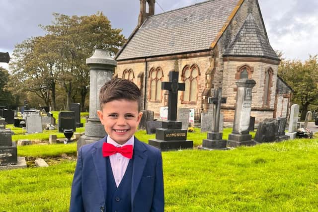 Six-year-old Abe Briffa outside Hindley Cemetery's chapel, where he was baptised
