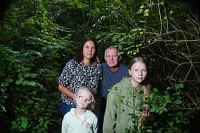 Natalie and Bill Gibson with grandchildren Maddison Eaves, five, and Bella Eaves, 10, on the overgrown path near the River Douglas