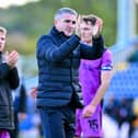 Ryan Lowe applauds the Wigan Athletic fans