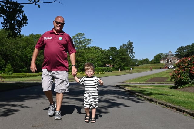 Mark Hesketh has fun in the sun with grandson Noah, two, on a walk around Mesnes Park, Wigan.