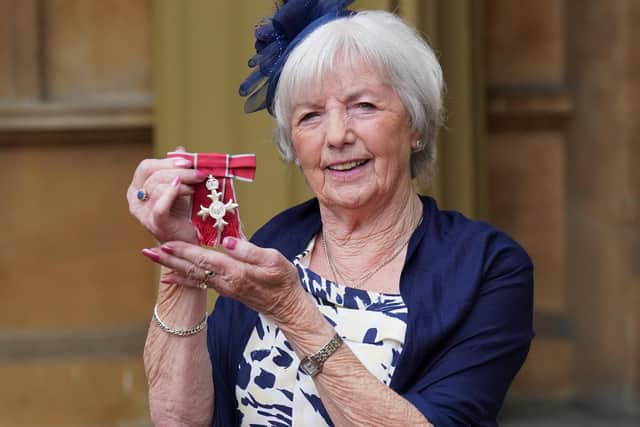 Marie McCourt with her MBE at Buckingham Palace