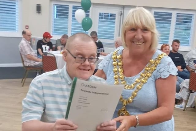 Student Jeffrey presented with his certificates by The Mayor of Wigan Coun Marie Morgan.
