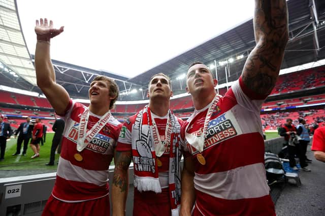 Chris Tuson with Logan Tomkins and Sam Tomkins following Wigan's 2013 Challenge Cup win