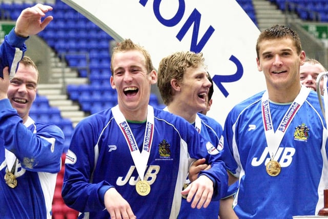 Happy days for Latics players after receiving their medals as Wigan Athletic lift the Division 2 championship trophy after beating Barnsley 1-0 with a Tony Dinning goal  on Saturday 3rd of May, the last day of the 2002/2003 season. 