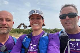 Three of the walkers with the Isle of Jersey's giant woven puffins artwork in the background, including (far right) Damian Glynn, brother of MND sufferer Chris Glynn