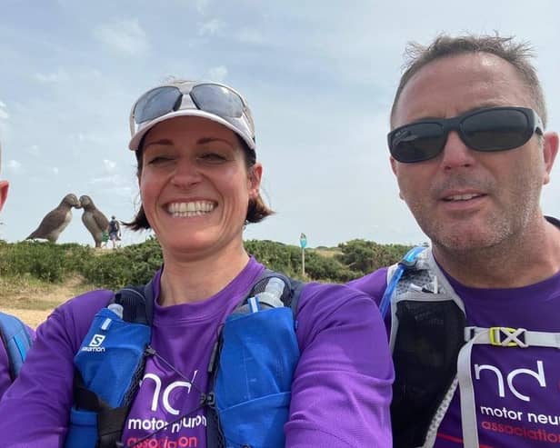 Three of the walkers with the Isle of Jersey's giant woven puffins artwork in the background, including (far right) Damian Glynn, brother of MND sufferer Chris Glynn