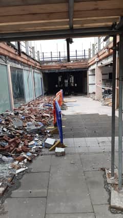 A look into the gradually disappearing Marketgate shopping centre from Market Place. The first section is now open to the skies