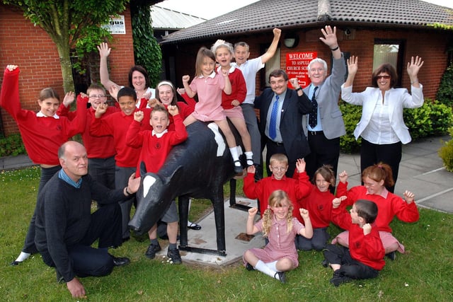 2008 - The return of the iconic cow outside Aspull Church School from pupils, Head, Carol Aspinall, right, Assistant Head, Jacqui Seddon, councillors Chris Ready and John Hilton and creator Philip Brown.