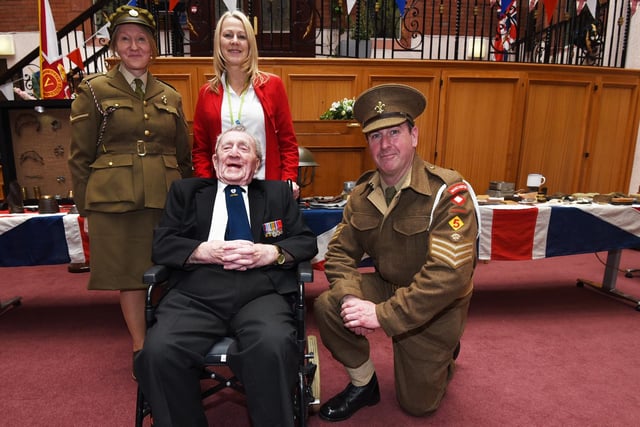 Deborah Pugh, left, and Dave Myers, right, from 5th Bn. Manchester Regiment Living History Museum and forces keyworker Gillian Burchall, centre, meet Wigan's oldest veteran, 99-year-old Harry (Henry) Cullen.