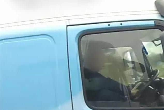 A driver with his right foot on the dashboard (Highways England/PA)