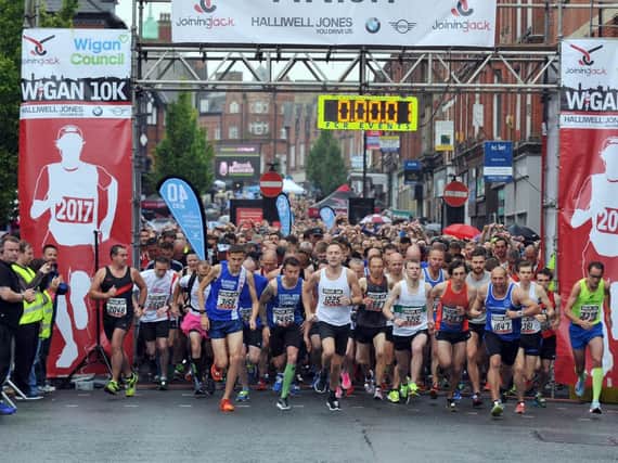 Runners cross the start line at last years Wigan 10k
