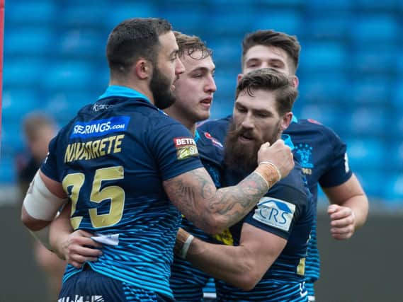 Warriors players celebrate a try in their win at Salford