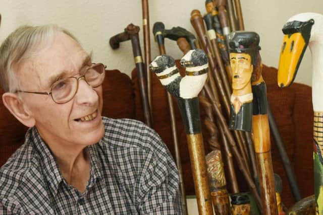 Frank Walton and his collection of walking sticks