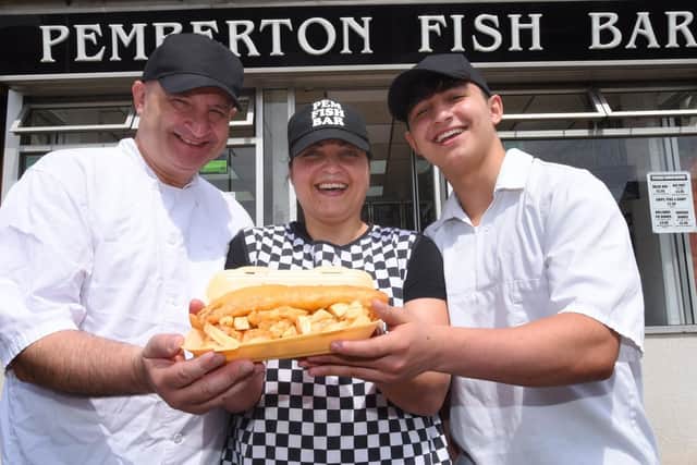 Tony and Maria Papakyriacou from Pemberton Fish Bar, Ormskirk Road, Pemberton, are celebrating the 20th anniversary of the family business, pictured with son Dasos, right.