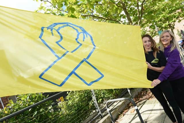 The yellow flag is unfurled in Wigan's Believe Square for World Suicide Prevention Day