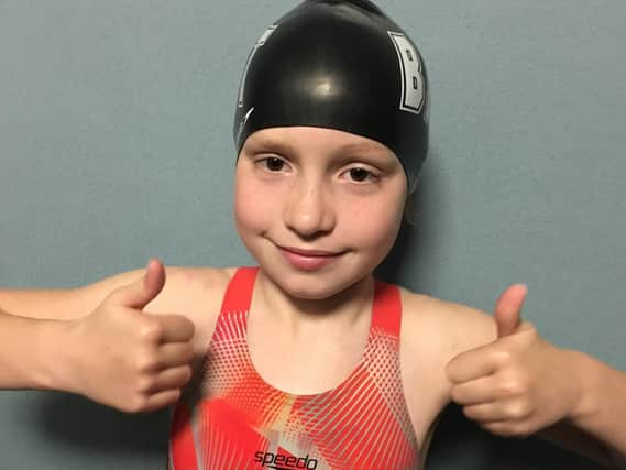 Evie Cutter gives the thumbs up after her incredible swimming efforts