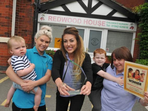 Staff from left, Athena Harris, Kate Edwards and Claire Thompson, and kids at Redwood House Children's Nursery, Orrell, celebrate winning Wigan Post Nursery of the Year