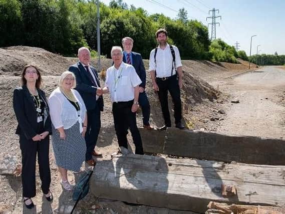 Council leader Coun David Molyneux and town hall officials at the site of the link road
