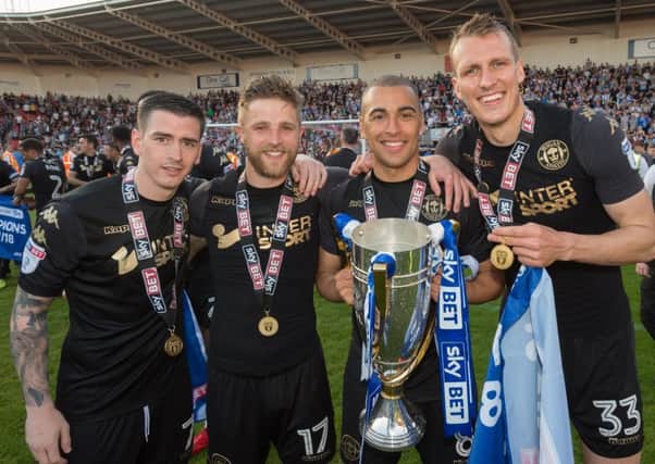 Michael Jacobs (second left) celebrates picking up the League One title