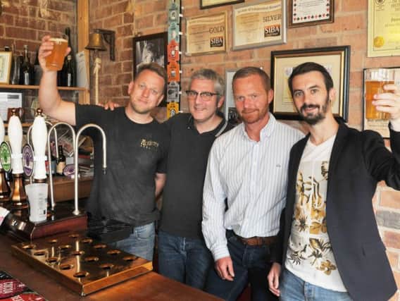 Head brewer Jonathan Provost, left, and director Martin Blythe, second from right, at Wigan Brewhouse, welcome Benoit Durand head brewer in Wigan's twin town Angers and Angers ambassador Martin Pouvreau, right, as they have created a special beer celebrating the 30th anniversary of the twinning
