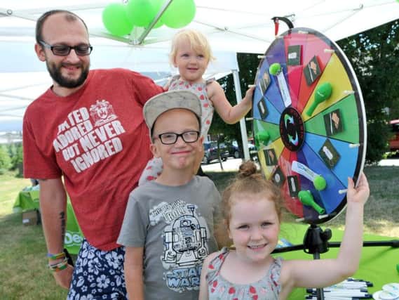Scott Parkinson with Evana Parkinson, Hudson Dunn and Erica Parkinson and the spin a wheel stall