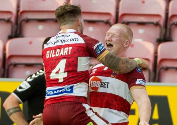 Liam Farrell celebrates his try with Oliver Gildart