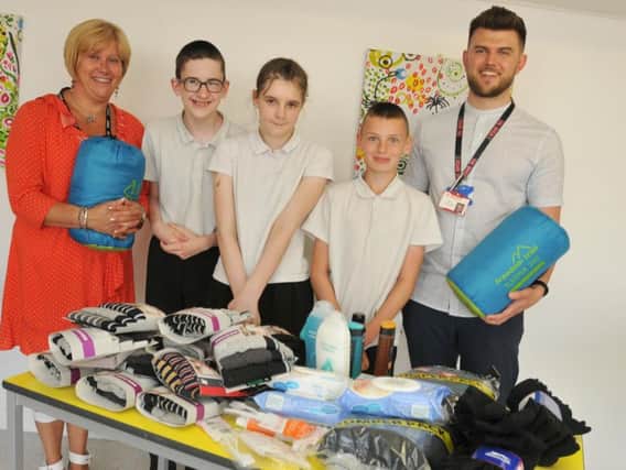Assistant headteacher Helen Leach with pupils Callum Moore, 16, Charlotte Banks, 13, and Scott Anderson, 12, from Hope School and The Brick charity project manager James Leach-Holt,