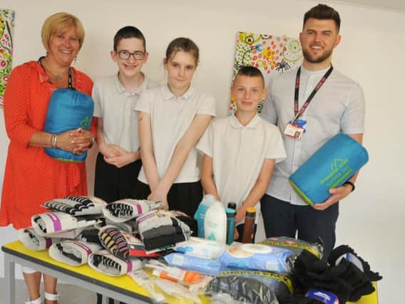 Assistant headteacher Helen Leach with pupils Callum Moore, 16, Charlotte Banks, 13, and Scott Anderson, 12, from Hope School  and The Brick charity project manager James Leach-Holt,