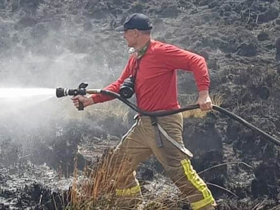 A firefighter tackling the blaze on Winter Hill