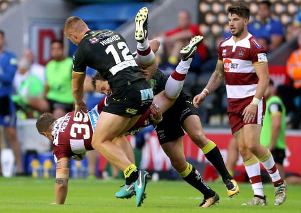 Warrington's Tyrone Roberts tackles Wigan Warriors Liam Paisley during the Betfred Super League match at The DW Stadium, Wigan. PRESS ASSOCIATION Photo. Picture date: Friday July 6, 2018. See PA story RUGBYL Wigan. Photo credit should read: Richard Sellers/PA Wire. RESTRICTIONS: Editorial use only. No commercial use. No false commercial association. No video emulation. No manipulation of images.